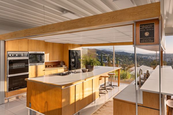 The modernist residence features a steel-and-glass construction and an open floor plan.