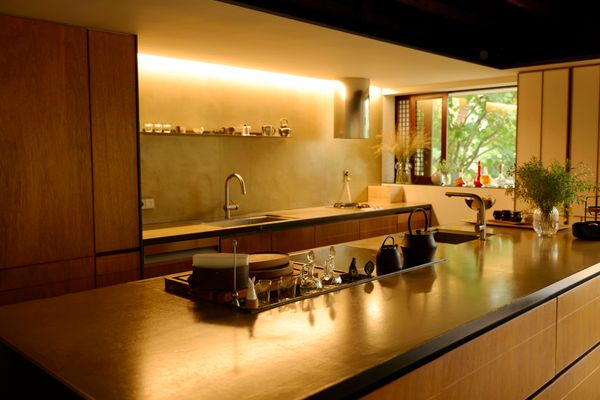 The open kitchen is the heart of the home—there is no living room. The island was designed by Wook Choi.