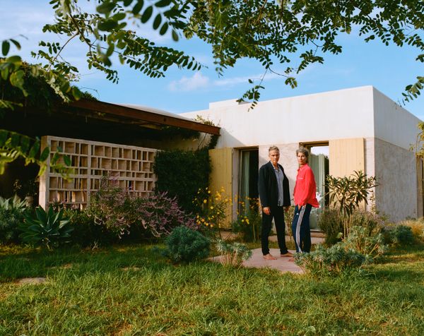 The home is surrounded by vegetation. The outdoor living and dining area is set roughly 50 feet from the swimming pool.