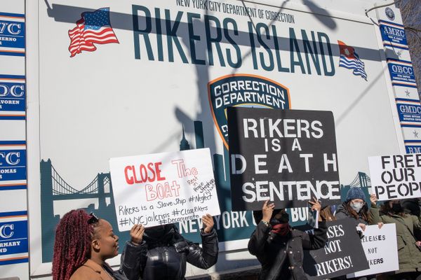 Criminal justice activists stage a demonstration at the gate to Rikers Island in Queens, New York, in February 2022. 