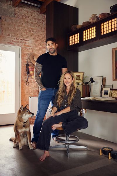 The antique coat hooks were sourced from Etsy. A pottery collection comprised of Pre-Columbian and Kenyan pieces sits atop the shoji screen cabinets. The vintage desk lamp is by Veneta Lumi.