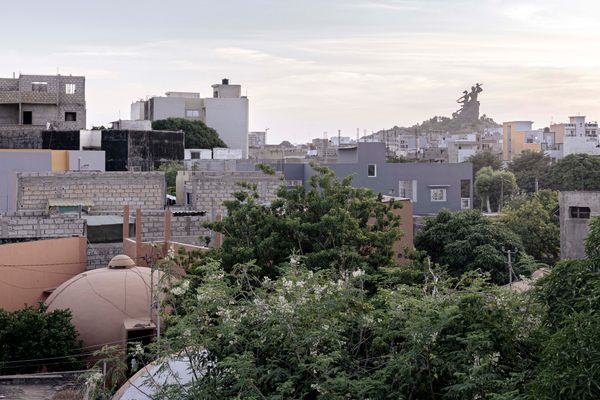 Ouakam is the Dakar district with the highest concentration of remaining bubble houses in the city. The African Renaissance Monument, a key urban landmark of Senegal’s capital, looms on a hill in the background.