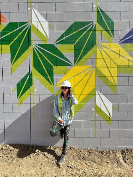 Artist Sandra Fettingis installing her mural at Sprouts Market in Aurora, Colorado.
