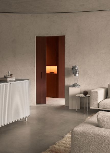 The entryway, window frames, and round-edged millwork are clad in sapele mahogany.