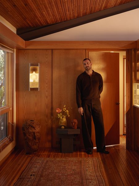 Designer and maker Nick Pourfard is constantly experimenting with his 1988 Walter S. White home in Escondido, as with a prototype of a glass sconce hanging in the entry. The sculpture in the corner is by Ben Day Todd, and the end table is by Steven Hartzog.