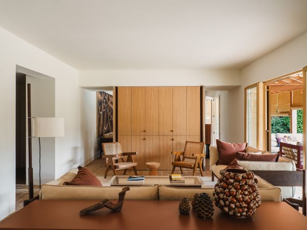 The Kofi coffee table is from Hay. The teak Jeanneret lounge chairs are from Srelle. The oak wall unit was designed by Anna and Eugeni Bach.