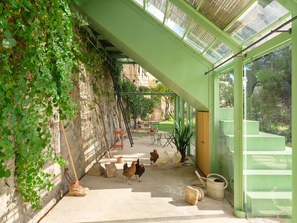 Polimone decided to rent a flock of Livornese chickens from an organic farm for this photo shoot. They wander beneath the the mint-green, powder-coated steel steps that connect two terraces on the property.