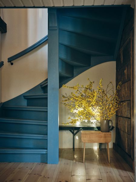Shaker-style milk paint is featured throughout the house, including the eye-catching blue staircase added by Friso and Mare.