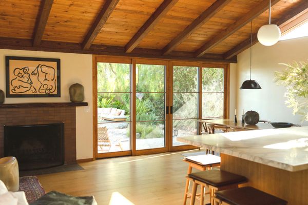 The Skobys combined the original walled-off entryway, kitchen, living room, and dining area into one bright, open space. To vault the ceilings, they had to install a 26-foot-long central support beam. The clerestory windows they added give the house the feel of an iconic midcentury.