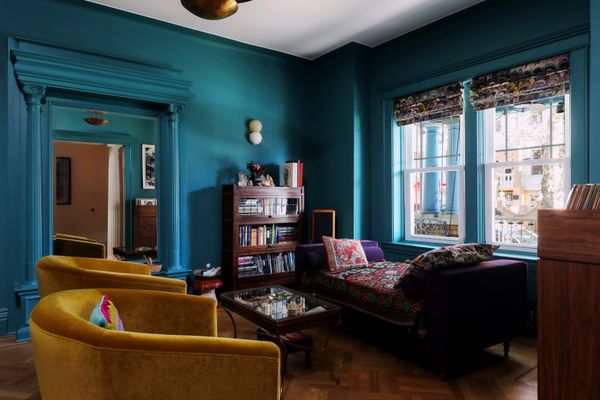 Theresa Mershon and Michelle Erfer brought their shared passion for color to the recent renovation of a 1910 town house in Queens, New York. Working with architect Luki Anderson of Studio Officina and color consultant Holly Faulkner, the couple employed a total of 17 shades in the 2,073-square-foot home, including Fruit Fool in the dining alcove and Vardo in the parlor. The velvet Tegan swivel chairs are from Interior Define. The Twin wall sconce is by Karen Gilbert for SkLO.