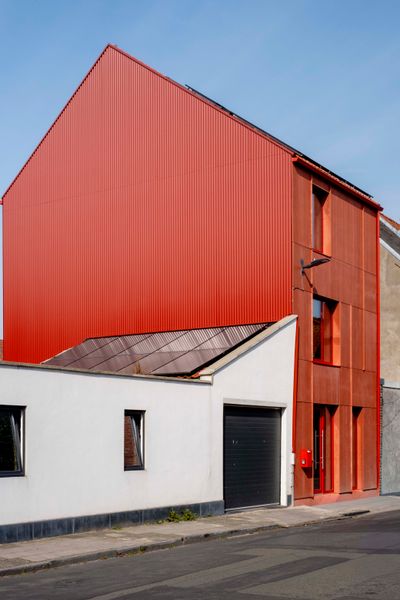 Karina Soors, founder of Belgium-based creative agency Studio Woot Woot, worked with architect Bruno Van de Calseyde of Denc-Studio to design her home in Ghent. The bright red siding is made of Viroc, a composite of wood particles and cement.