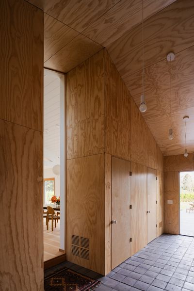 Campbell’s clients wanted the home to feel calming, so for the entry he used plywood and charcoal-stained terra-cotta tiles.