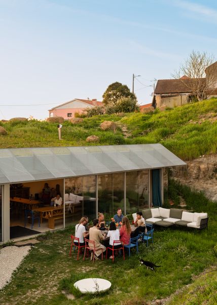 Guests gather outside one of three new buildings designed by architecture firm Fala for Fools’ Valley, a co-living space set in a valley 40 minutes from Lisbon. Renting rooms for short or extended stays and offering workshops and events as well as a quiet place to work, the compound is the brainchild of British philosopher/lawyer Chris Wray and Russian entrepreneur Liza Simonova.