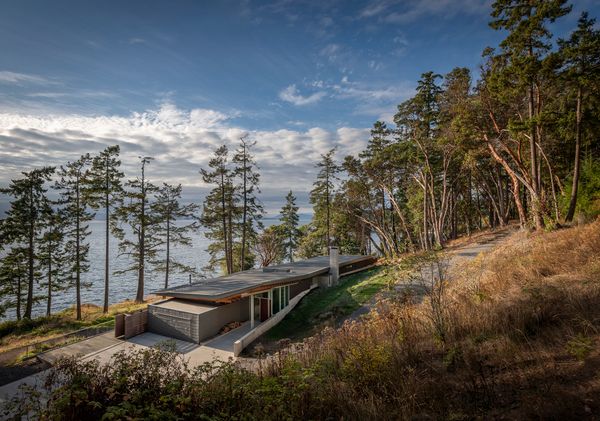 The San Juan Island Residence occupies six-acres along the western coast of San Juan Island, with 400 feet of shoreline overlooking Haro Strait. Designed by Bohlin Cywinski Jackson, the back of the home appears tucked into the hillside, while the front opens toward the water.