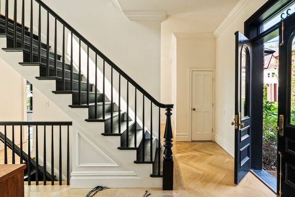 Restored pocket doors, 10- to 12-foot ceilings, and new white oak herringbone floors nod to the home’s 19th-century roots.