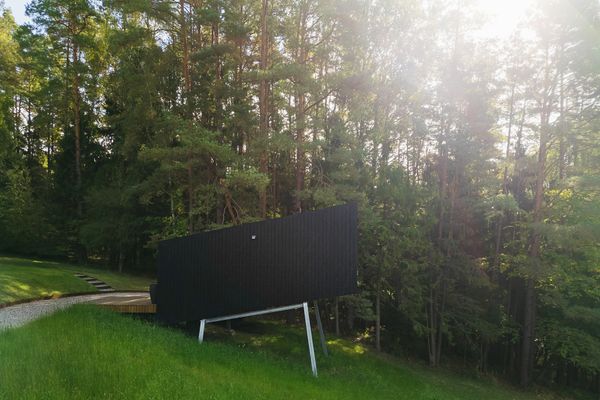 The 200-square-foot cabin is set on a four-legged metal frame that aims it up for a view of the trees.