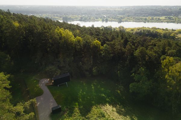 Wanting a remote-feeling retreat while visiting family in his hometown of Kulautuva, Lithuania,  Marius Bernotas built a spatially efficient tiny cabin on land he purchased for $49,000. The Nemunas River flows nearby.
