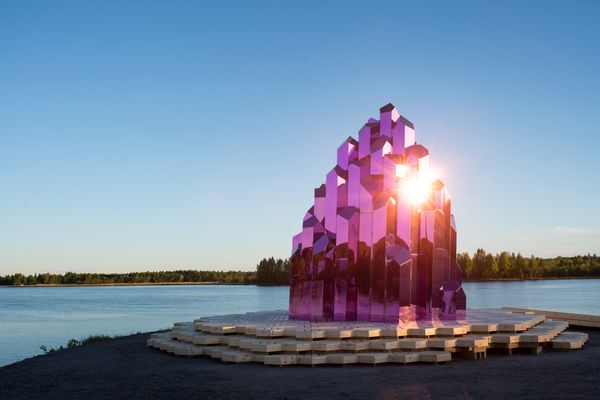 A shimmering purple sauna made of titanium-coated stainless steel helps turn a former industrial site into a playful climate conversation.