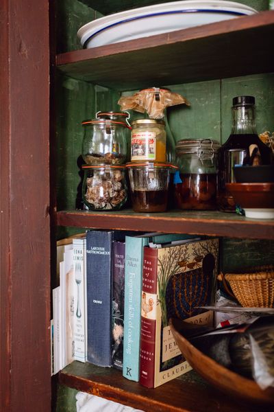 The secondhand antique cabinet is filled with food preservation projects, as well as her most prized cookbooks.