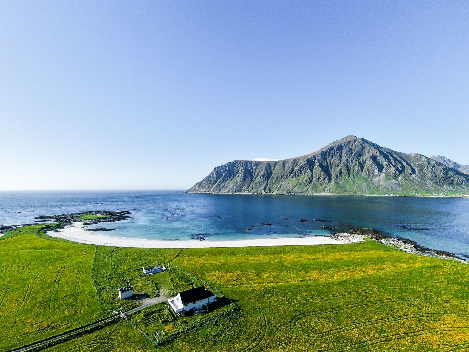 In a small fishing village in the Lofoten archipelago, this 1950 wood-paneled house sits at the literal end of the road, with a berry-filled garden, a practically private beach, and a brand-new outdoor sauna.