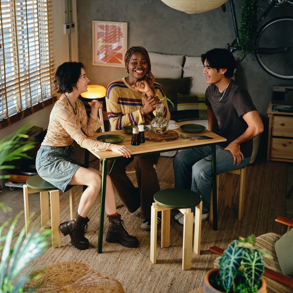 The furniture in Kompishäng is low profile, but that’s one of its greateast assets. When dinnertime is over, the table can be folded away and the stools can cleanly stack atop each other.