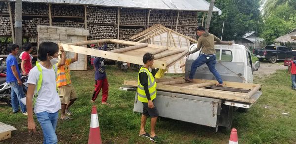 Workers load bamboo panels onto a truck at Kawayan Collective’s facility.