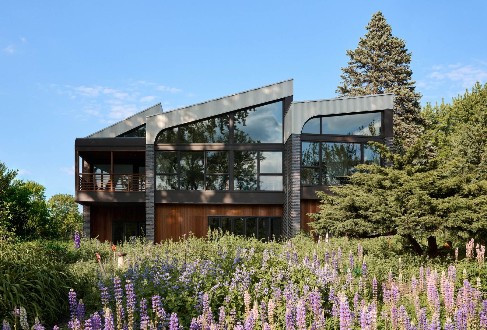 The 4,200-square-foot home, aptly named Crescendo, features lifted rooflines rising in sequence across the plan.