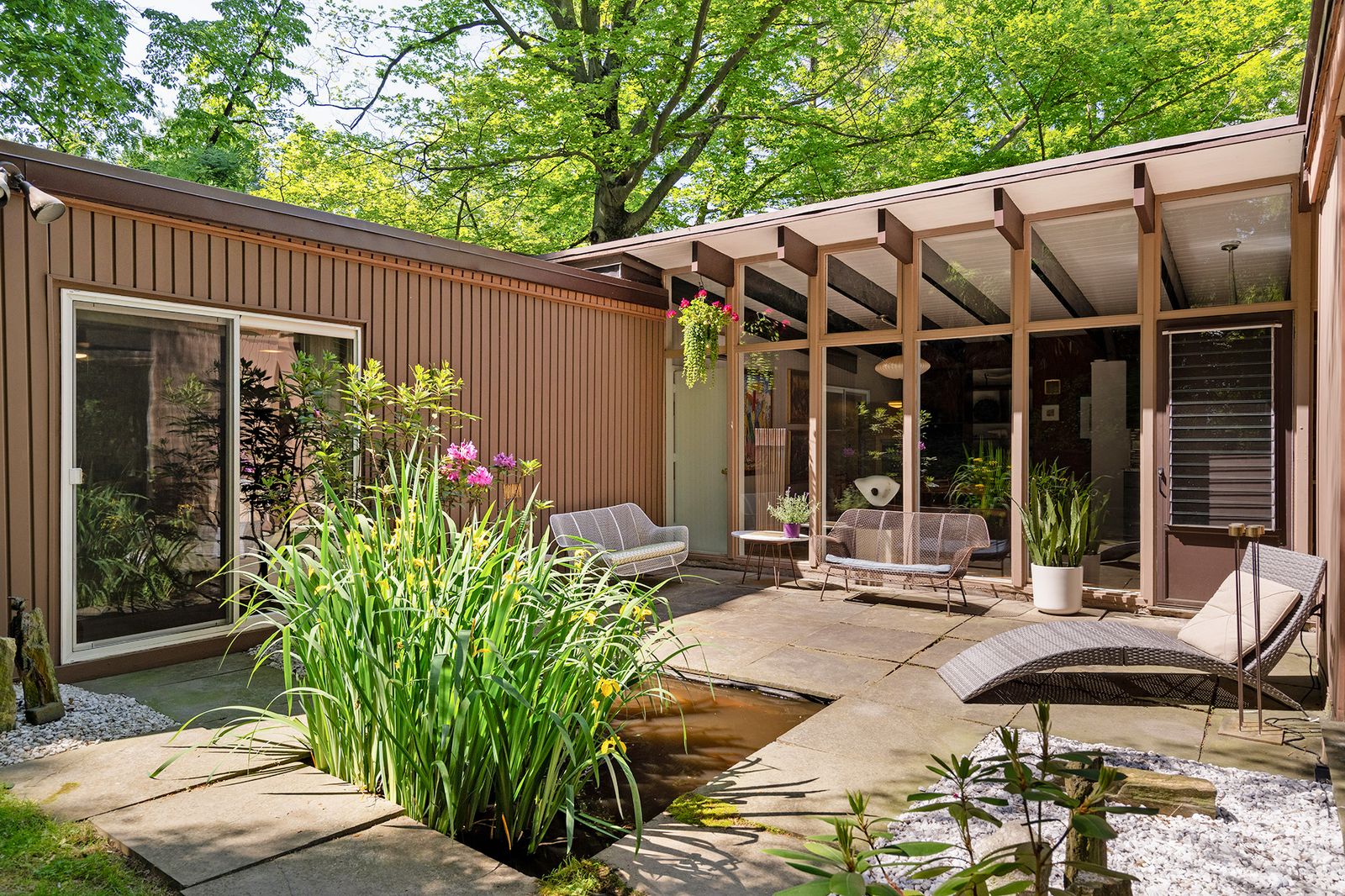 In the Philadelphia suburbs, this 1957 home by Carlos Joseph Alvaré has 10-foot walls of glass, exposed Douglas fir beams, fieldstone facades, and a lush, Japanese-inspired garden.