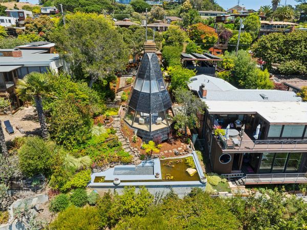 Set on a 6,500-square-foot waterfront lot in Point Richmond, California, Lumiere House was designed and built by Walter Thomas Brooks for his family. Terraced gardens, mature trees, and water features surround the home.