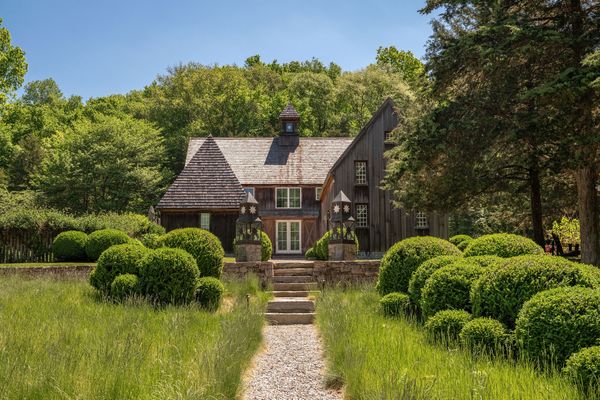 The 23-acre property in Lyme, Connecticut, was originally an 18th-century Cape, but now includes several buildings arranged around meticulously landscaped grounds.