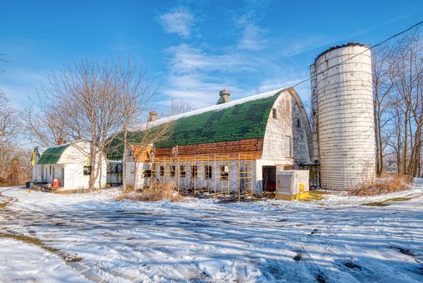 The 9,800-square-foot home was converted from an abandoned dairy barn, with its original stone silo still attached to the main structure.