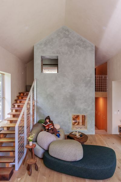 The house features a lofted suite with a sleeping nook and a double-height living area. <a href="https://www.earthenendeavors.com/">Earthen Endeavors</a> installed the fireplace wall using <span style="font-family: Theinhardt, -apple-system, BlinkMacSystemFont, "Segoe UI", Roboto, Oxygen-Sans, Ubuntu, Cantarell, "Helvetica Neue", sans-serif;"><a href="http://earthausplaster.com">Earthaus</a> Sand Finish lime plaster</span><span style="font-family: Theinhardt, -apple-system, BlinkMacSystemFont, "Segoe UI", Roboto, Oxygen-Sans, Ubuntu, Cantarell, "Helvetica Neue", sans-serif;"> and Andy White, of </span><a href="https://www.borealdesignvt.com/