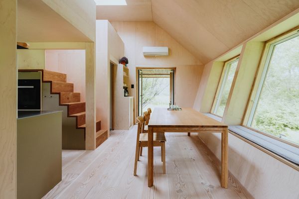 Through the entrance is the dining area and kitchen. Slanted walls give the interiors a roomy feel.