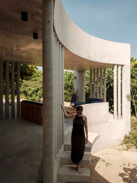 Built around a large, circular courtyard that gives the home its name, Casa O is a coastal retreat in southern Mexico conceived by California-based designer Ana Lasala. Apart from the kitchen, the public areas of the house have no perimeter walls. Instead, a total of 75 tall, slender columns, spaced just inches apart, curve around the courtyard and partially line the otherwise open living and dining areas.