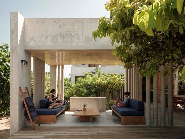 Ana sits with her children, Agáta, 13, and Pablo, 11, in the open living area.