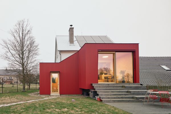 Zuzana Fuhrmannova and Tomas Binder bought a cabin they had been renting and expanded it with a red addition, designed and constructed by Facha Architekti.