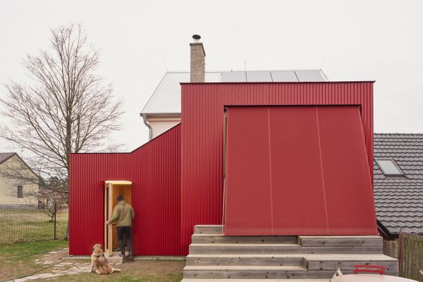 A red awning reaches down to the deck to provide complete shade to the interiors.