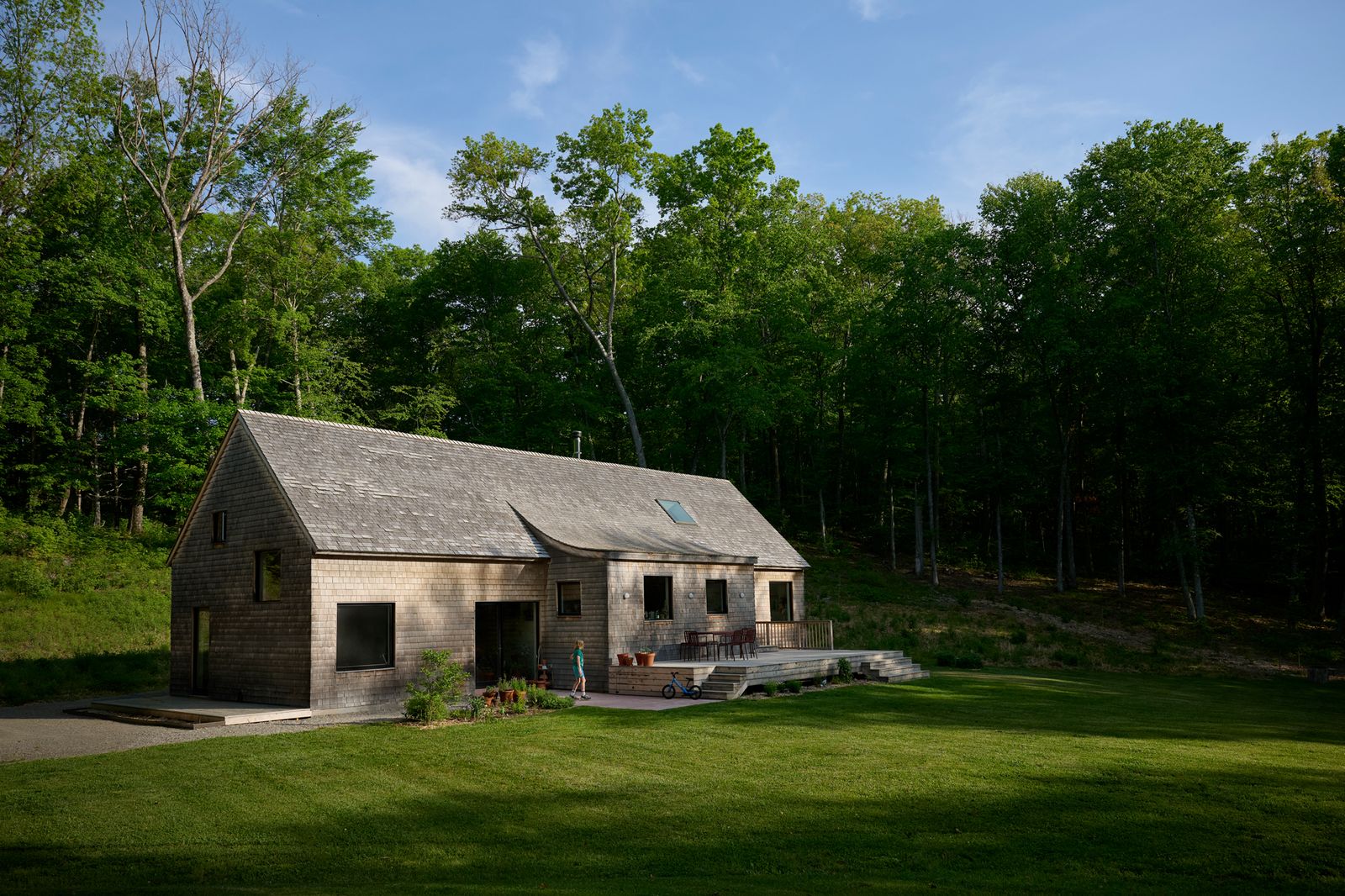 New York City–based GRT Architects designed this 1,500-square-foot, cedar-shingled house in Millbrook, New York for a young family who were living in a Brooklyn one-bedroom before moving upstate. 