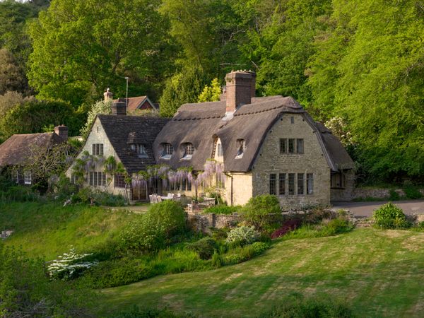 Designed by leading Arts and Crafts architect Alfred Powell in 1899 for Mrs. Mudie-Cooke, Long Copse began as a four-room summer retreat made to resemble a modest Surrey cottage. As its owner's ambitions grew, so did the house, gradually evolving into the larger country home it is today.