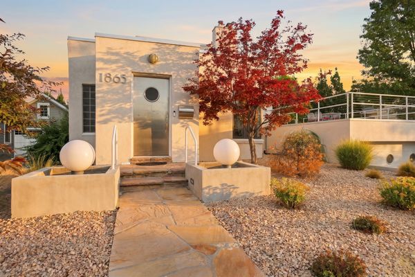The home's rounded corners, metal railings, and porthole windows reflect the nautical influences of Streamline Moderne design. Architect Jerrold Green added the stainless-steel front door during a 1998 expansion.