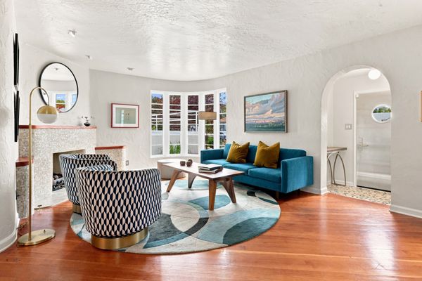 The home's rounded corners, metal railings, and porthole windows reflect the nautical influences of Streamline Moderne design.