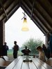 An open-air terrace off the kitchen features a Marina table and Captain chairs from Extremis. Photo 7 of Wynant House modern home