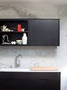Carrera marble as covers this whole wall. The cabinets are floating which look great, but the finish on the cabinets have been tough to keep looking good! Photo of The Deam House modern home