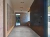 Modern home with Hallway and Concrete Floor. The client possessed a collection of art to be placed in the home, which was meticulously considered in the design process. Drywall was used exclusively and deliberately to hang the artwork to each piece’s necessary measurement. Photo 3 of Wyoming Residence