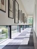 Modern home with Hallway, Rug Floor, and Concrete Floor. An art gallery was designed with low windows to allow natural light to permeate while protecting the sensitive art from harmful direct sunlight. It is these careful details that, in combination with the striking lineation of the home, create a harmonious alliance of function and design. Photo 4 of Wyoming Residence