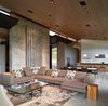 Modern home with Living Room, Sectional, Concrete Floor, Coffee Tables, End Tables, Recessed Lighting, and Rug Floor. The living area is voluminous yet intimate. A built-in seating nook maintains a direct view of the mountains, unobstructed by a low profile fireplace. Photo 9 of Wyoming Residence