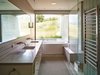 Modern home with Concrete Floor and Recessed Lighting. An indoor-outdoor bathroom further incorporates the exterior habitat. Photo 11 of Wyoming Residence