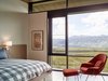 Modern home with Bedroom, Bed, Chair, and Concrete Floor. Windows in the guest bedrooms allow the ceiling to rest gently. Photo 12 of Wyoming Residence