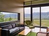 Modern home with Living Room, Chair, Coffee Tables, Recessed Lighting, Rug Floor, Concrete Floor, and End Tables. Glass walls open up onto a balcony on the rear of the home. Photo 13 of Wyoming Residence