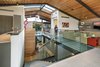 The space is configured as a loft-like modern treehouse with an inverted floorplan, positioning the primary living spaces on the top floor for maximum light exposure. Photo 5 of Cohen Residence modern home